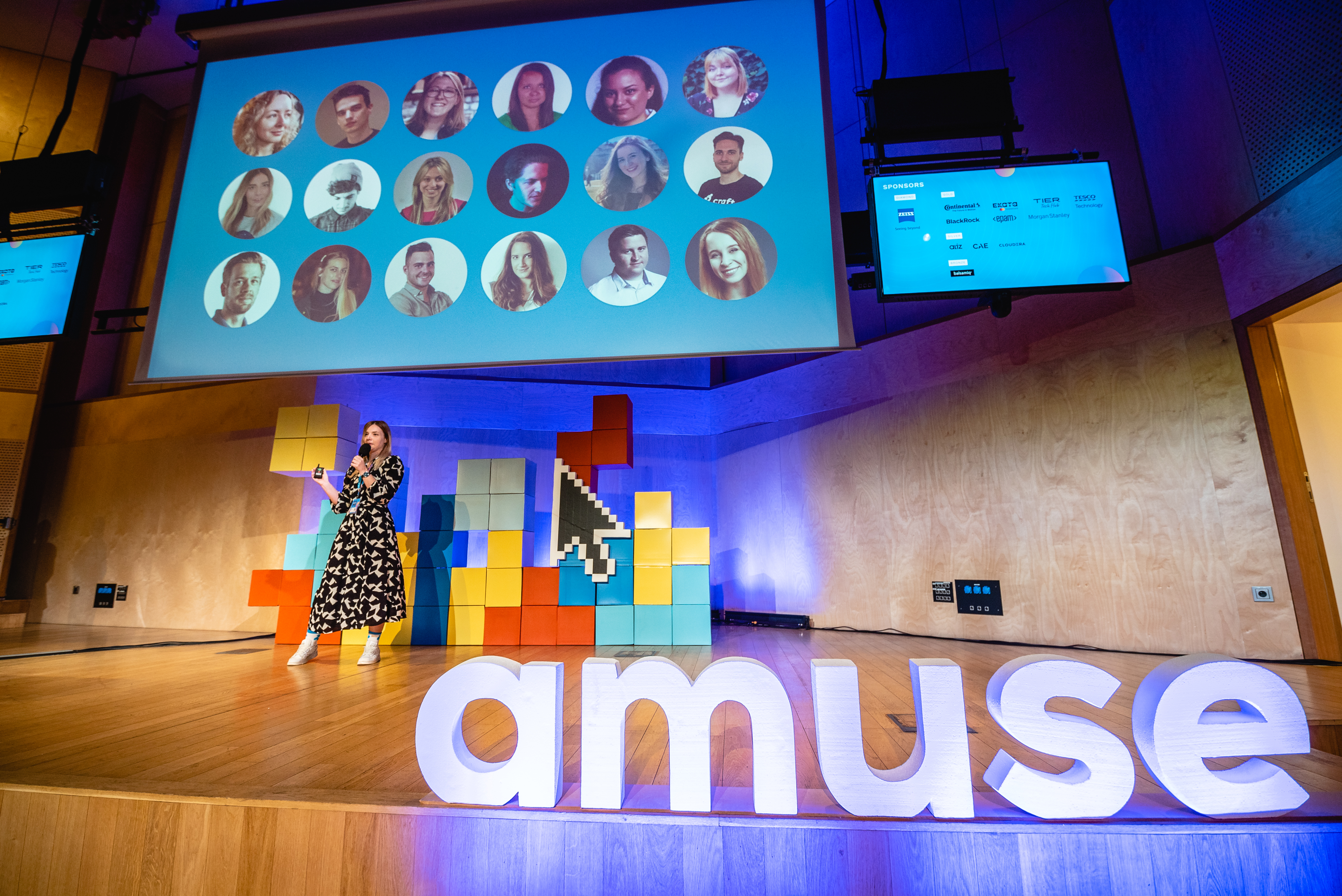 Nóra Pekker speaking into a microphone during a conference discussion