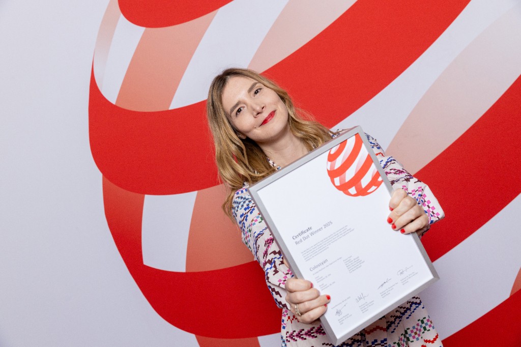 Nóra Pekker holding a Red Dot Winner 2025 certificate for Colossyan